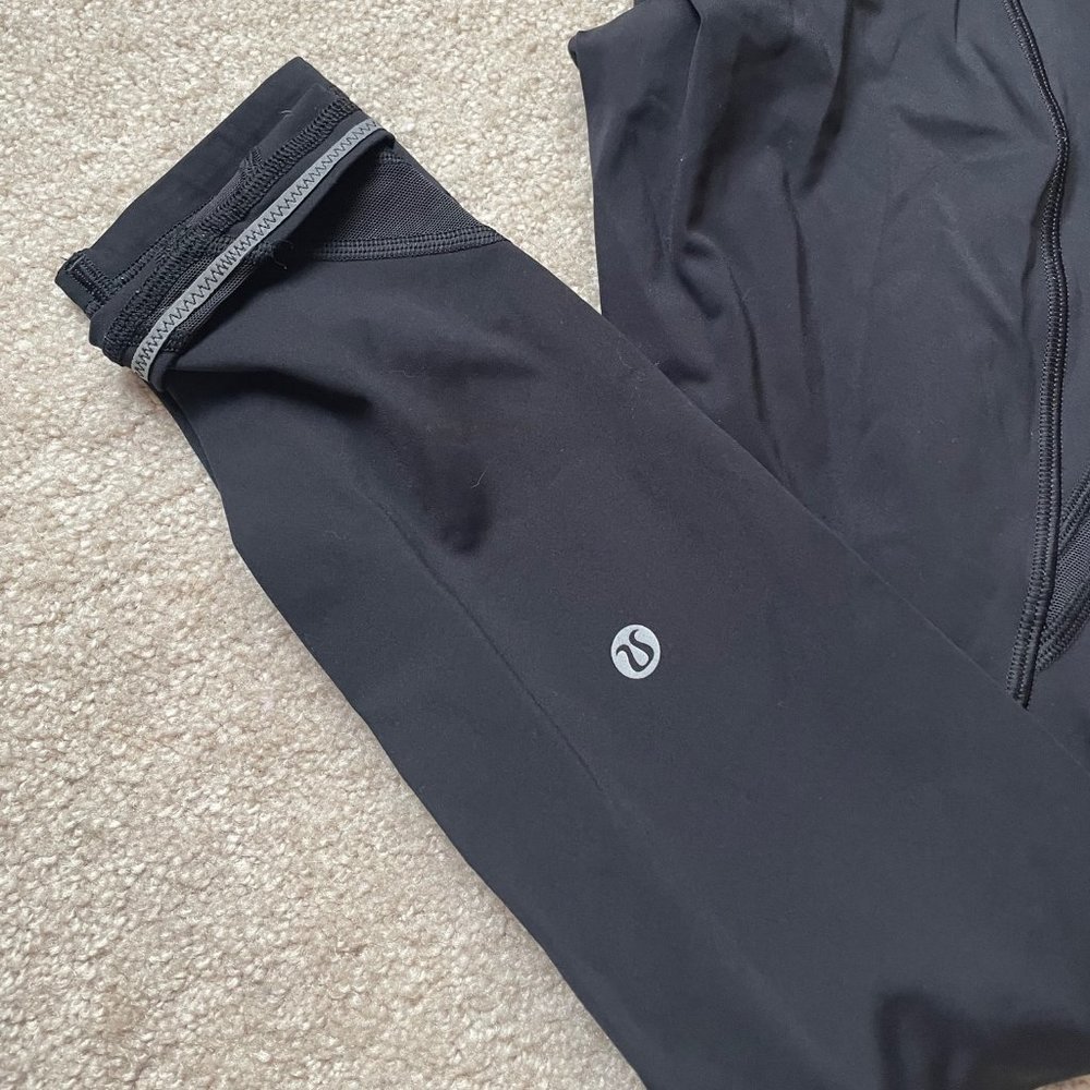 LULULEMON SIZE 4 NULUX BLACK LEGGINGS WITH MESH, POCKETS, AND REFLECTIVE TRIM